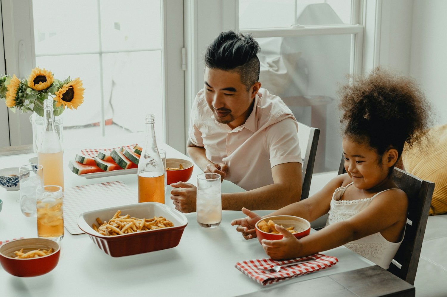 boy and girl eating on table